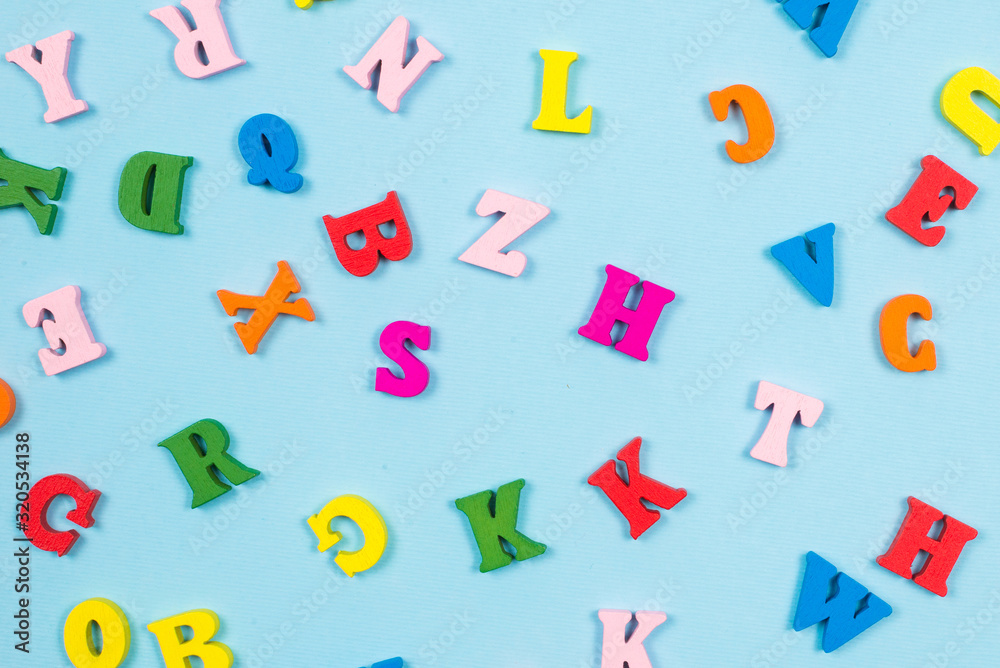 Fototapeta premium Multicolored letters on a blue background.