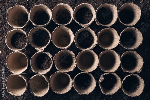Biodegradable peat pot on greenhouse compost humus soil