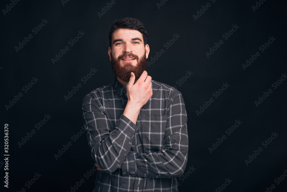 Studio portrait of a handsome man wearing a shirt on black background. Studio portrait of a handsome man wearing a shirt on black background.