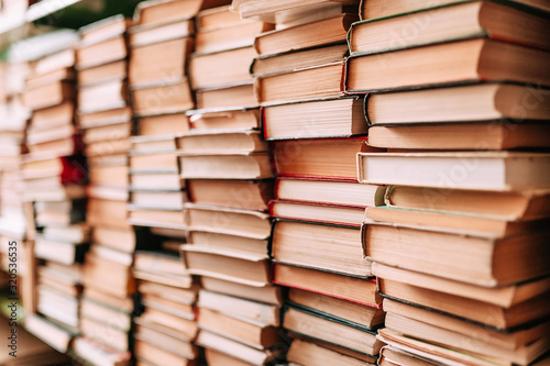 many old books are stacked on shelves. background of books