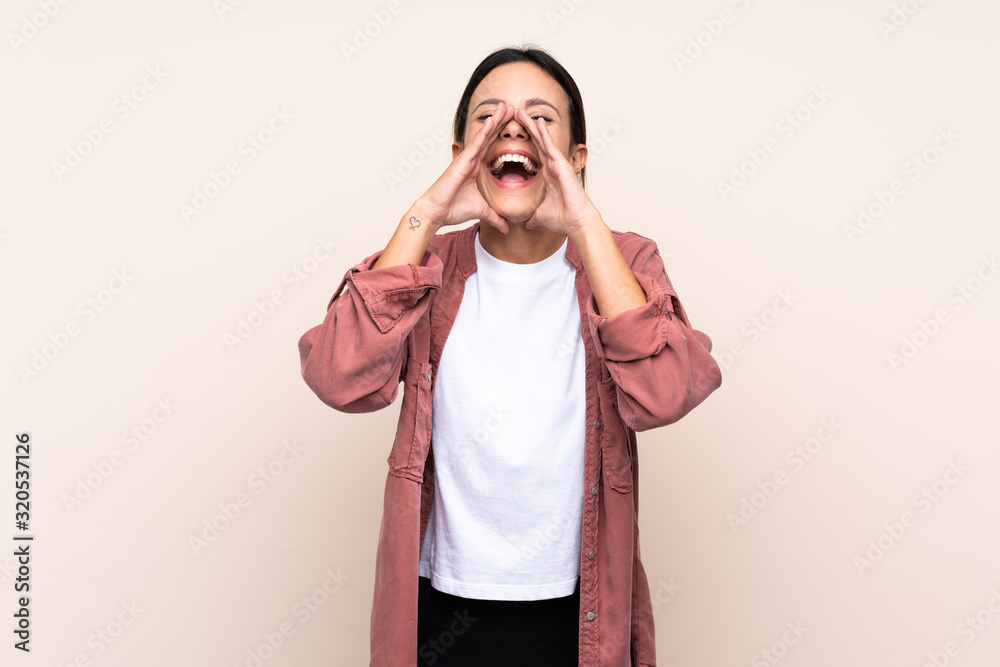 Woman over isolated background shouting and announcing something Woman over isolated background shouting and announcing something