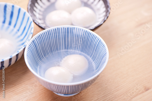 Delicious tang yuan, yuanxiao in a small bowl. Traditional festive food rice dumplings ball with stuffed fillings for Chinese Lantern Festival, close up.