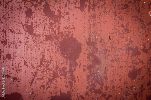View of red weathered flooring in building exterior.