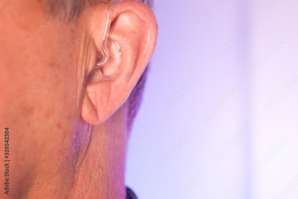 Naklejka premium Man with hearing aid