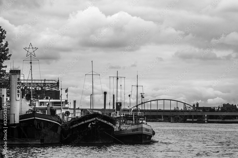 boats parked on river in black and white