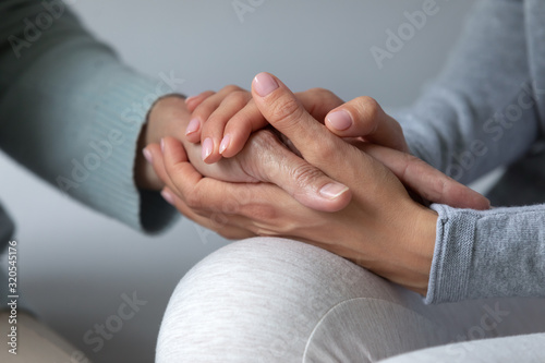 Photography Loving mother and daughter hold hands having close moment
