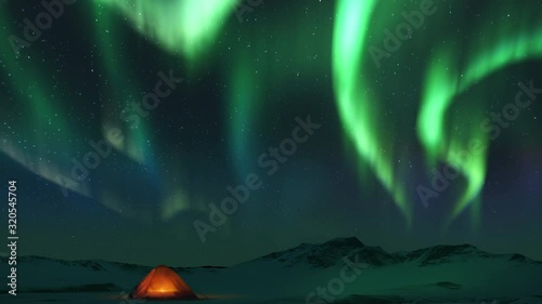 Animation of spectacular realistic Bright Aurora Borealis landscape. Touristic tent in the mountains. Time lapse clip of Polar Light or Northern Light in night sky. Dynamic stars motion on background