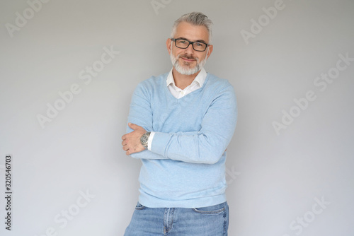 Portrait of 40 year old man, isolated on grey background
