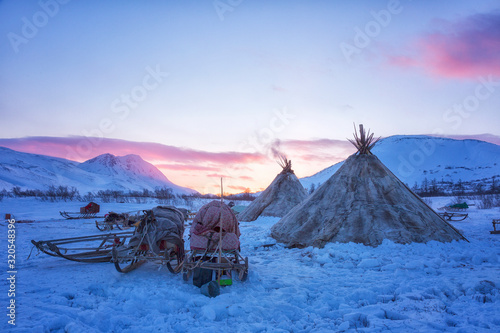 Nenets reindeer herders choom on a winter sunset photo