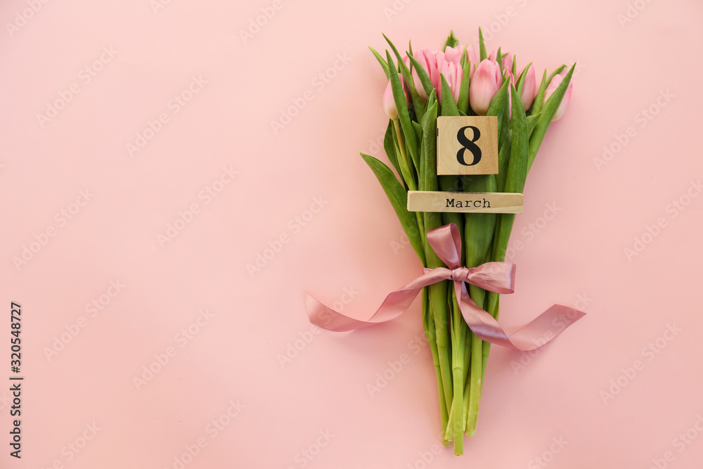 Fototapeta premium Drewniany kalendarz w kształcie sześcianu z datą 8 marca, święto Międzynarodowego Dnia Kobiet z pięknym bukietem różowych tulipanów. Zamknij się, skopiuj przestrzeń, tło. Koncepcja pozdrowienia wakacyjne.