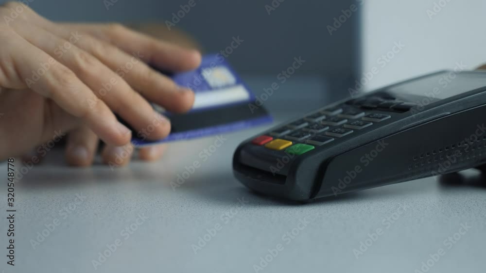 Payment by credit card, purchase and sale of goods and services. Credit card in the store. girl lifestyle pays the card reader online shopping concept Payment by credit card, purchase and sale of goods and services. Credit card in the store. girl lifestyle pays the card reader online shopping concept