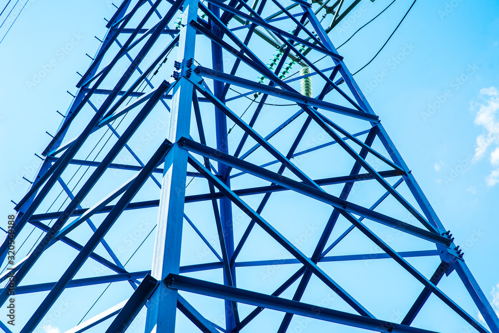 Telecommunication towers include of radio microwave and television antenna system with cloud blue sky and sun ray. Antenna tower, low angle view.