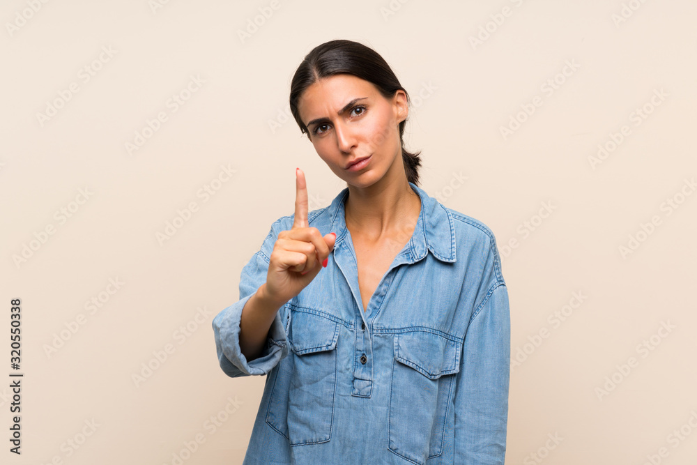 Young woman over isolated background frustrated and pointing to the front Young woman over isolated background frustrated and pointing to the front