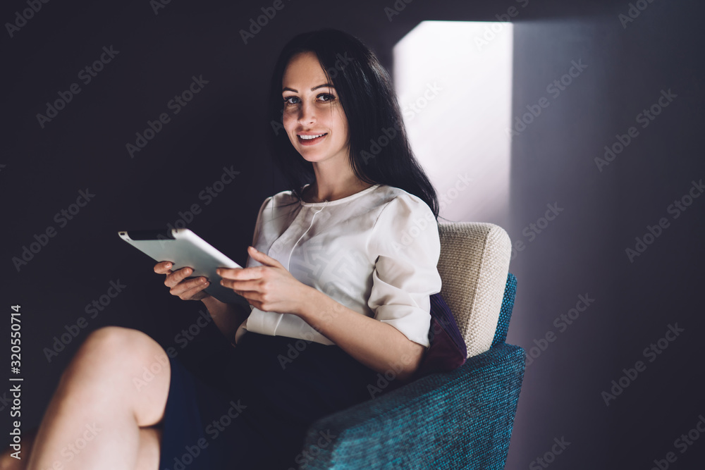 Beautiful pleased woman with gadget chilling in chair Beautiful pleased woman with gadget chilling in chair