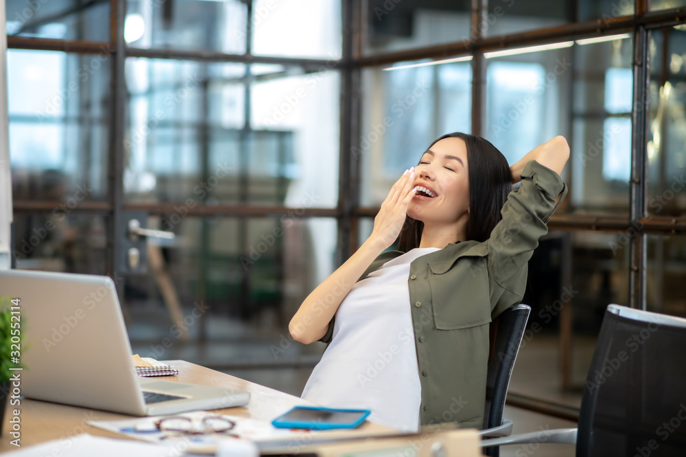 Long-haired brunette asian girl feeling tired and yawning Long-haired brunette asian girl feeling tired and yawning