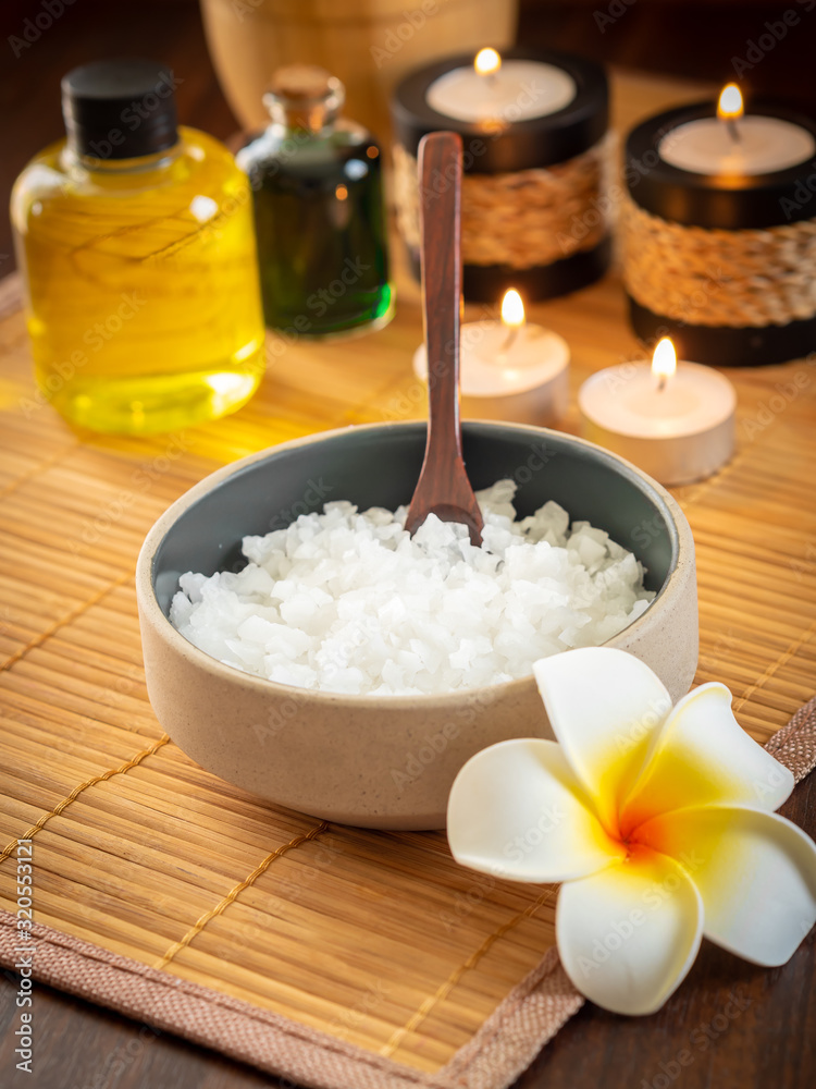 Spa pure mineral sea salts with bottles of massage oil and aromatheray candles Spa pure mineral sea salts with bottles of massage oil and aromatheray candles