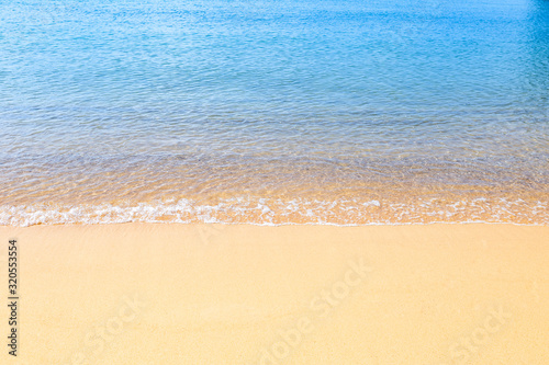 Empty clean sand beach with clear blue sea water, environmental concept, summer outdoor day light, holiday and vacation destination