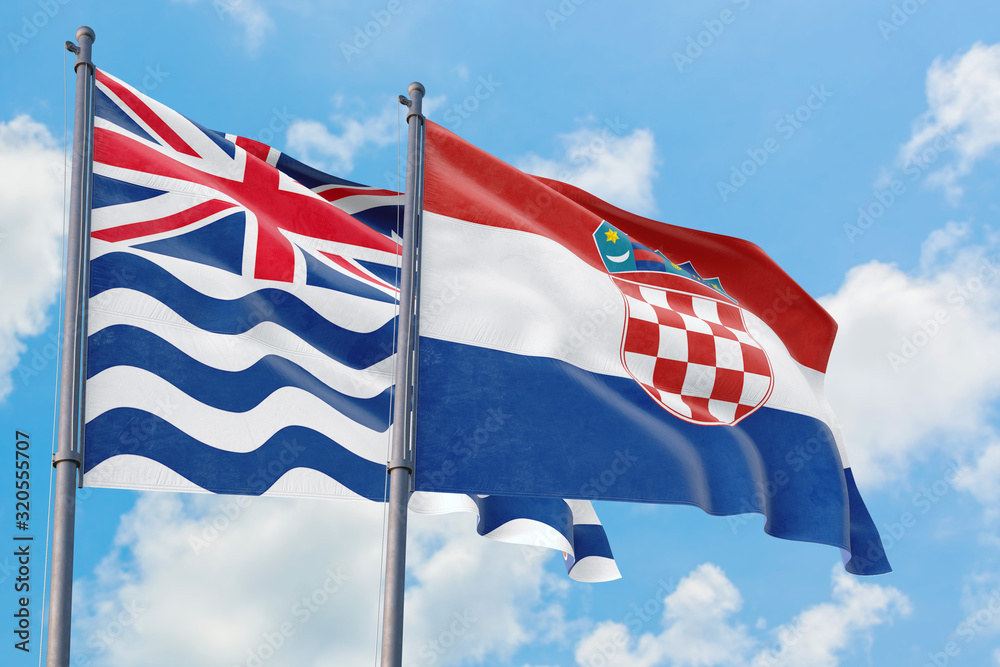 Croatia and British Indian Ocean Territory flags waving in the wind against white cloudy blue sky together. Diplomacy concept, international relations.