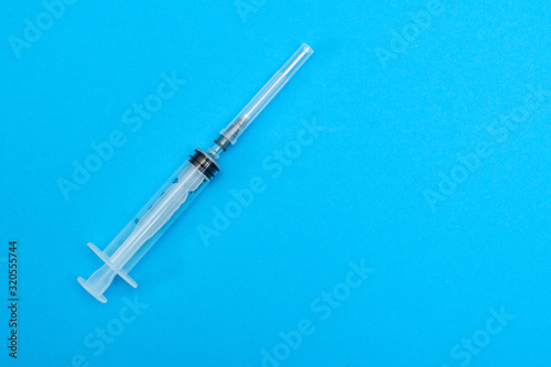 medical syringe on a blue background.