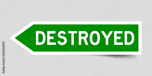 Green color arrow sticker with word destroyed on gray background