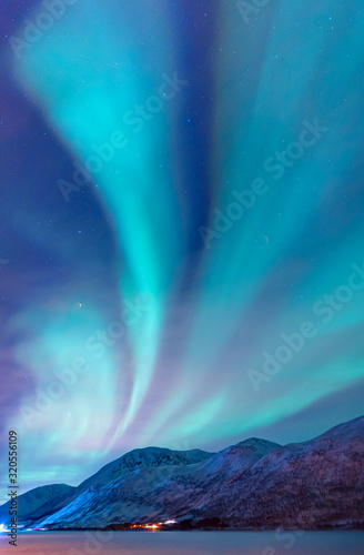 Fotografie, Obraz Northern lights (Aurora borealis) in the sky over Tromso, Norway