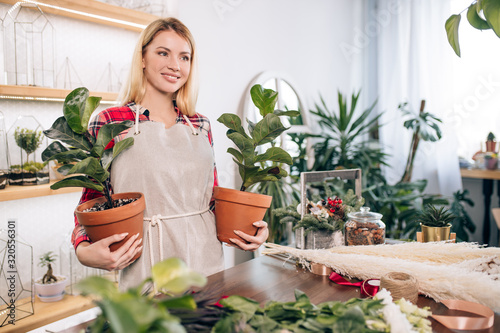 young caucasian woman florist at work, enjoy and love work with flowers, decorating and composing bouquet. botany, flowers, plants, nature concept