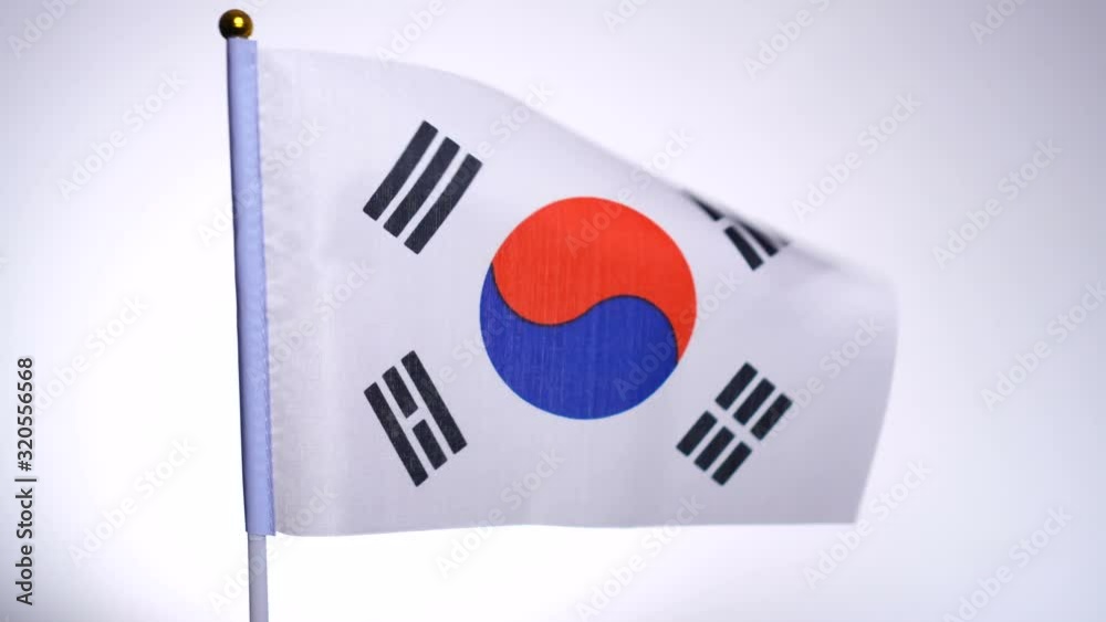 Flag of South Korea on flagpole flying and waving in the wind. Flag of South Korea on flagpole flying and waving in the wind.