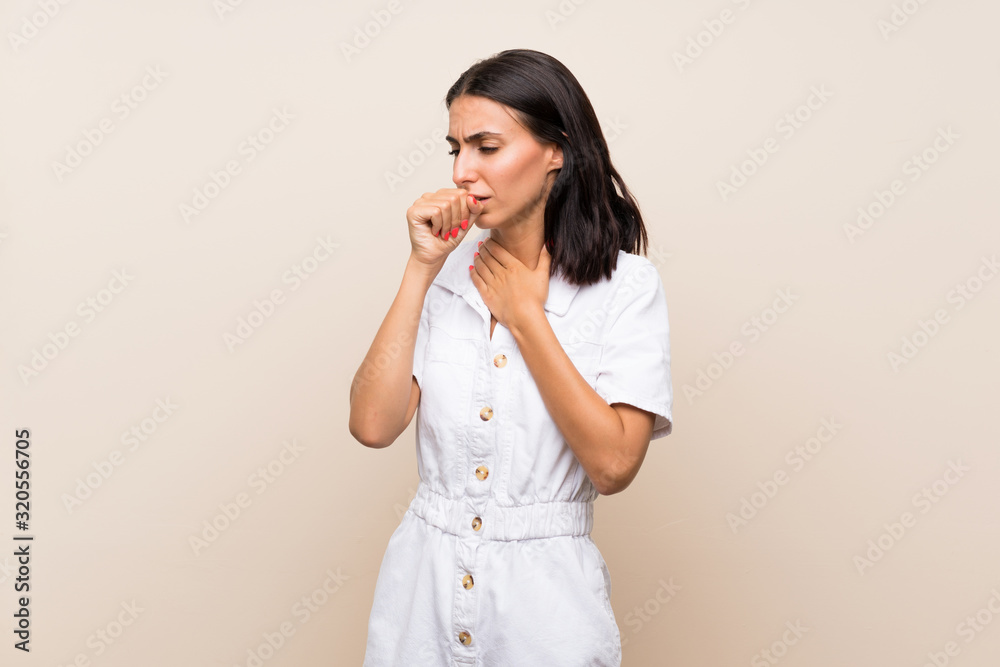Young woman over isolated background is suffering with cough and feeling bad Young woman over isolated background is suffering with cough and feeling bad