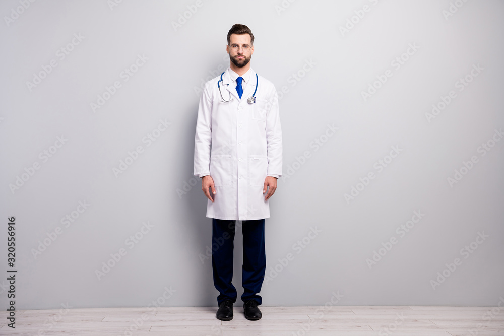 Full length body size view of his he nice attractive smart clever content serious doc first aid emergency center owner director surgeon isolated on light white gray pastel color background Full length body size view of his he nice attractive smart clever content serious doc first aid emergency center owner director surgeon isolated on light white gray pastel color background