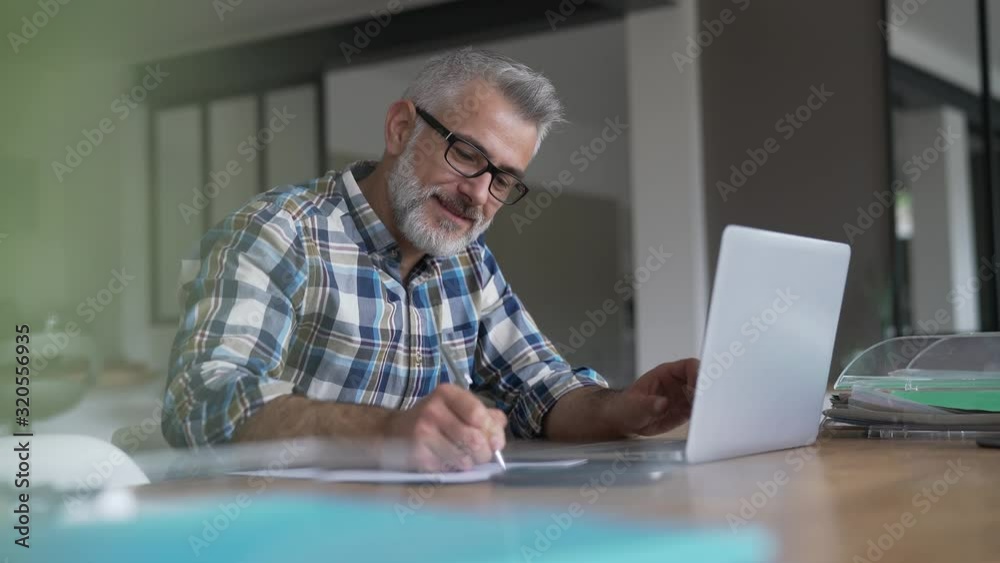 Man working from home on laptop computer