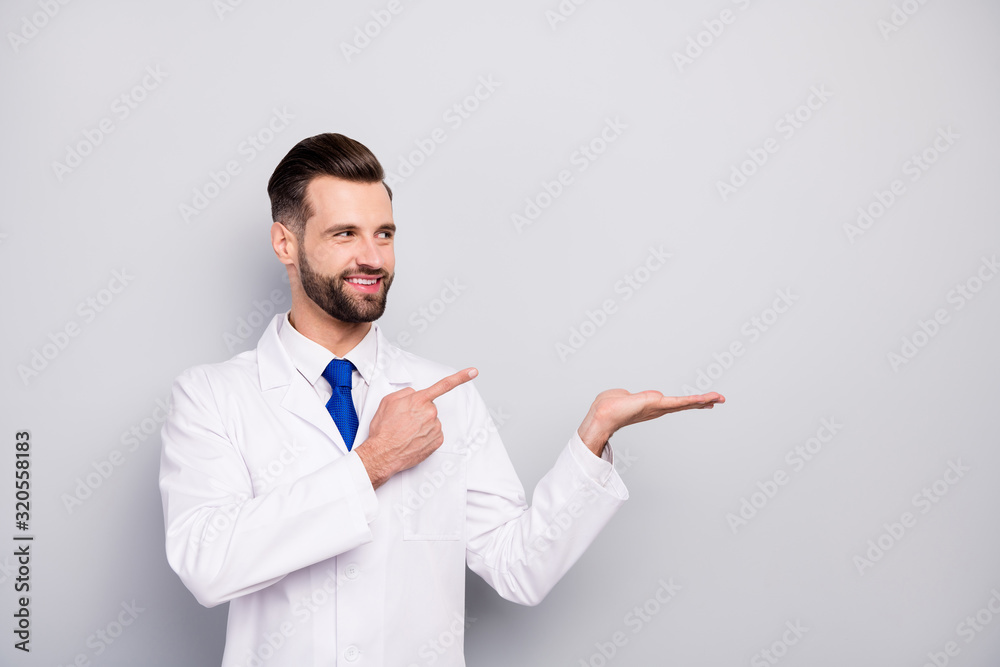 Portrait of his he nice attractive glad cheerful cheery confident doc holding on palm showing new novelty ad advert solution alternative isolated on light white gray pastel color background Portrait of his he nice attractive glad cheerful cheery confident doc holding on palm showing new novelty ad advert solution alternative isolated on light white gray pastel color background