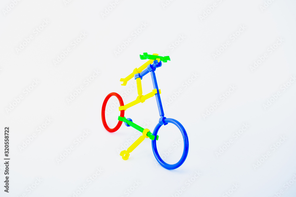Front view of a bicycle made of plastic shape shifting toy on a white isolated background. Front view of a bicycle made of plastic shape shifting toy on a white isolated background.