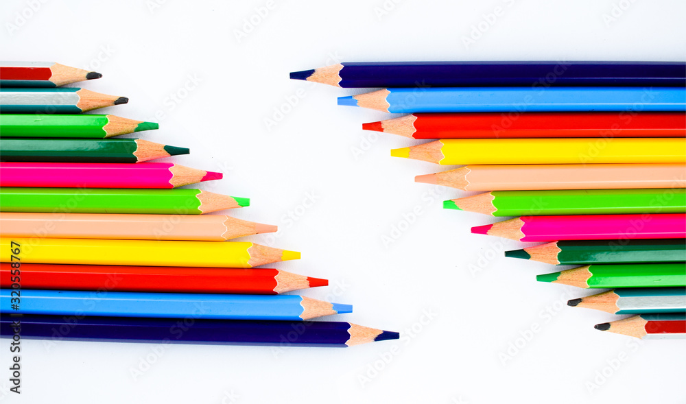 Collection of different colored pencil crayons arranged in two rows making a space for writing text Collection of different colored pencil crayons arranged in two rows making a space for writing text