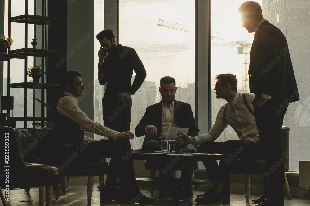 business coworking of young caucasian bearded men in office gathered to discuss business ideas, share experiences and opinions, successful cooperation of enthusiastic business people - obrazy, fototapety, plakaty 
