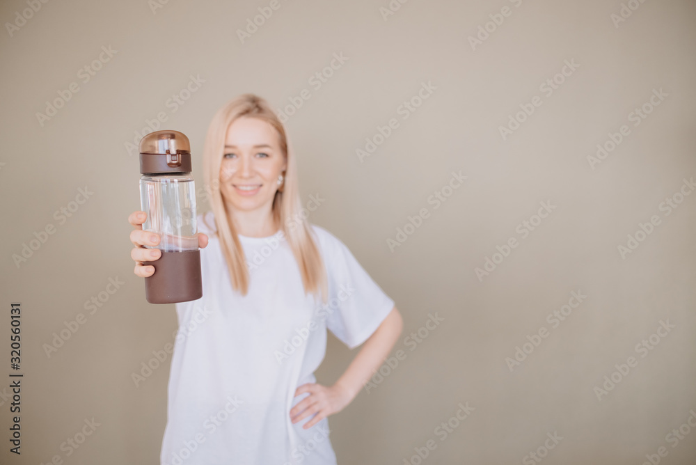smiling Woman holding reusable water sport bottle .Horizontal view copyspace Eco friendly and Zero waste smiling Woman holding reusable water sport bottle .Horizontal view copyspace Eco friendly and Zero waste