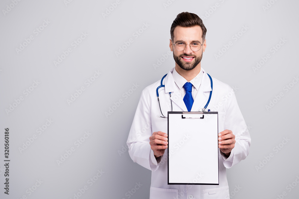 Portrait of nice attractive cheerful cheery bearded doc showing paper document agreement service terms insurance medicare first aid help assistance isolated on light white gray pastel color background