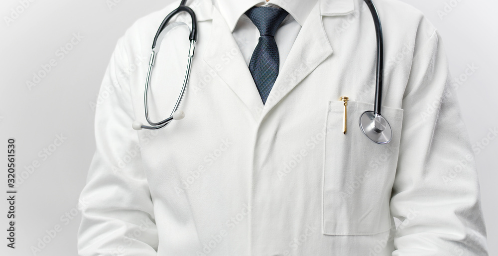 Cropped picture of male doctor wearing white coat, stethoscope, pen, and tie, front view