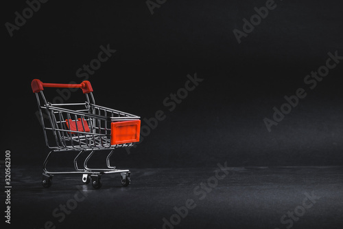 Shopping cart on dark background, business, shopping concept. Selective focus