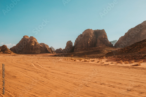Sand dunes in Wadi RAM in the morning, Jordan.Pink sand in the desert. the mountains are located in the wasteland.Blue sky and beautiful weather for traveling through the beauty of red sand.Bedouin's