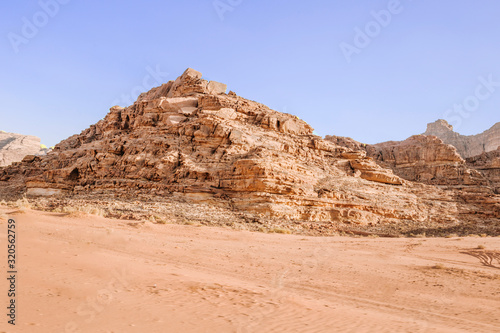 Sand dunes in Wadi RAM in the morning  Jordan.Pink sand in the desert. the mountains are located in the wasteland.Blue sky and beautiful weather for traveling through the beauty of red sand.Bedouin s