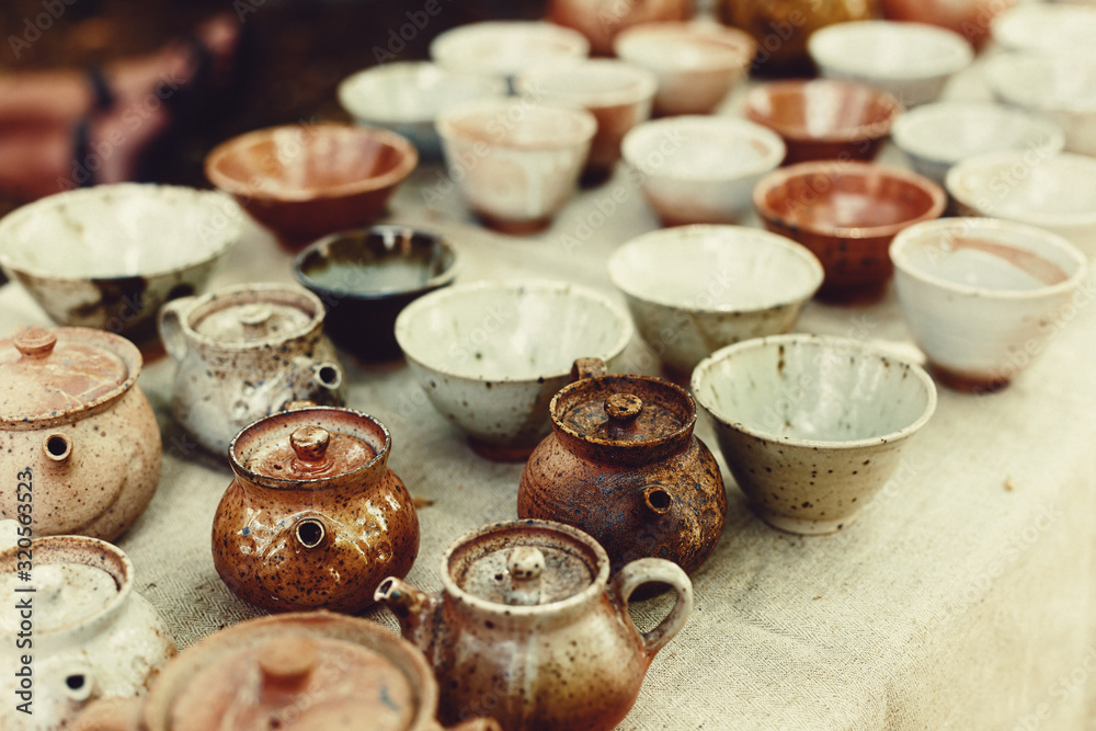 Beautiful clay teapots and mugs, fired ceramics.
