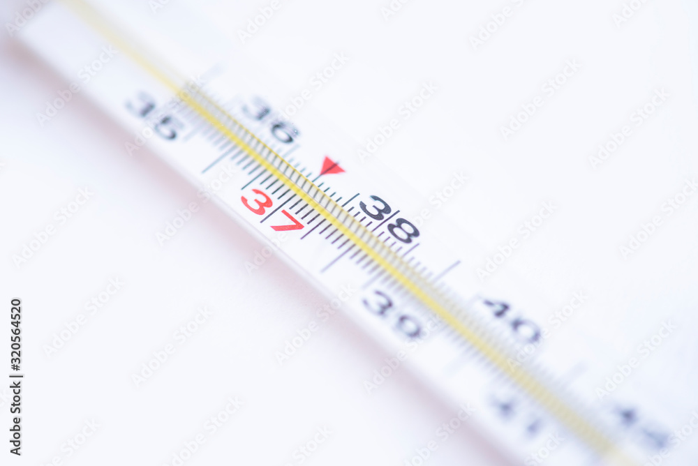 Close-up medical mercury thermometer on the white background. Close-up medical mercury thermometer on the white background.