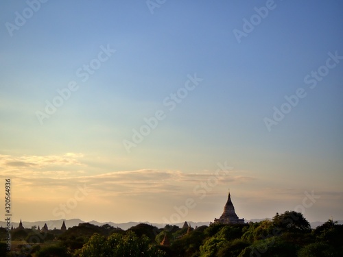 The evening landscape of Bagan, the World Heritage site of Myanmar with clear golden sky © Paphinvich