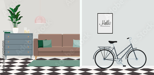 Bicycle by the wall in a modern living room interior with a chest of drawers, plant and sofa in the background