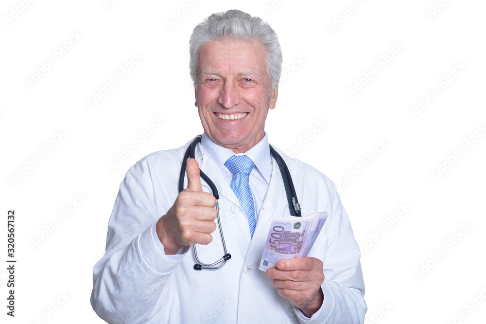 Senior male doctor holding money and showing ok Senior male doctor holding money and showing ok