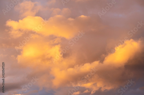 evening sky with beautifully sunlit clouds as a natural background © westermak15
