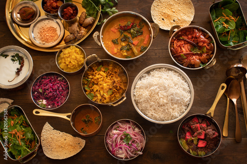 South Indian vegetarian dishes served in thali style on wooden table photo