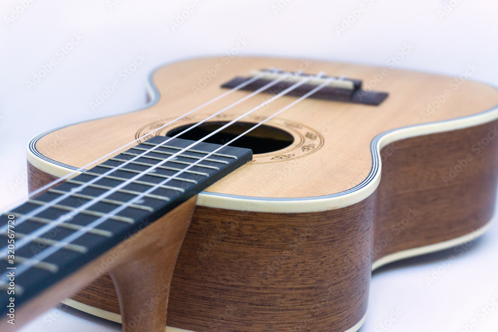 Fototapeta premium Brown ukulele hawaiian guitar isolated on white background
