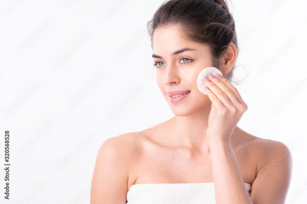 Young woman cleansing her face Young woman cleansing her face