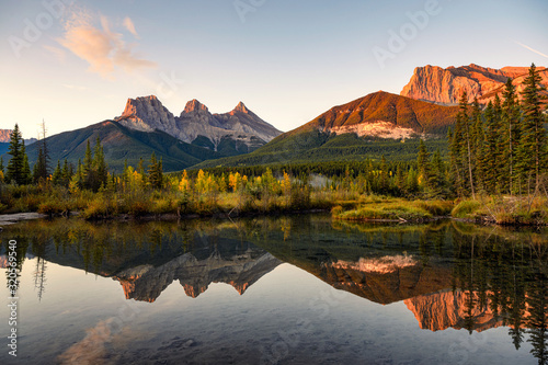Scenery of Three sisters mountains reflection on pond at sunrise in autumn at Banff national park